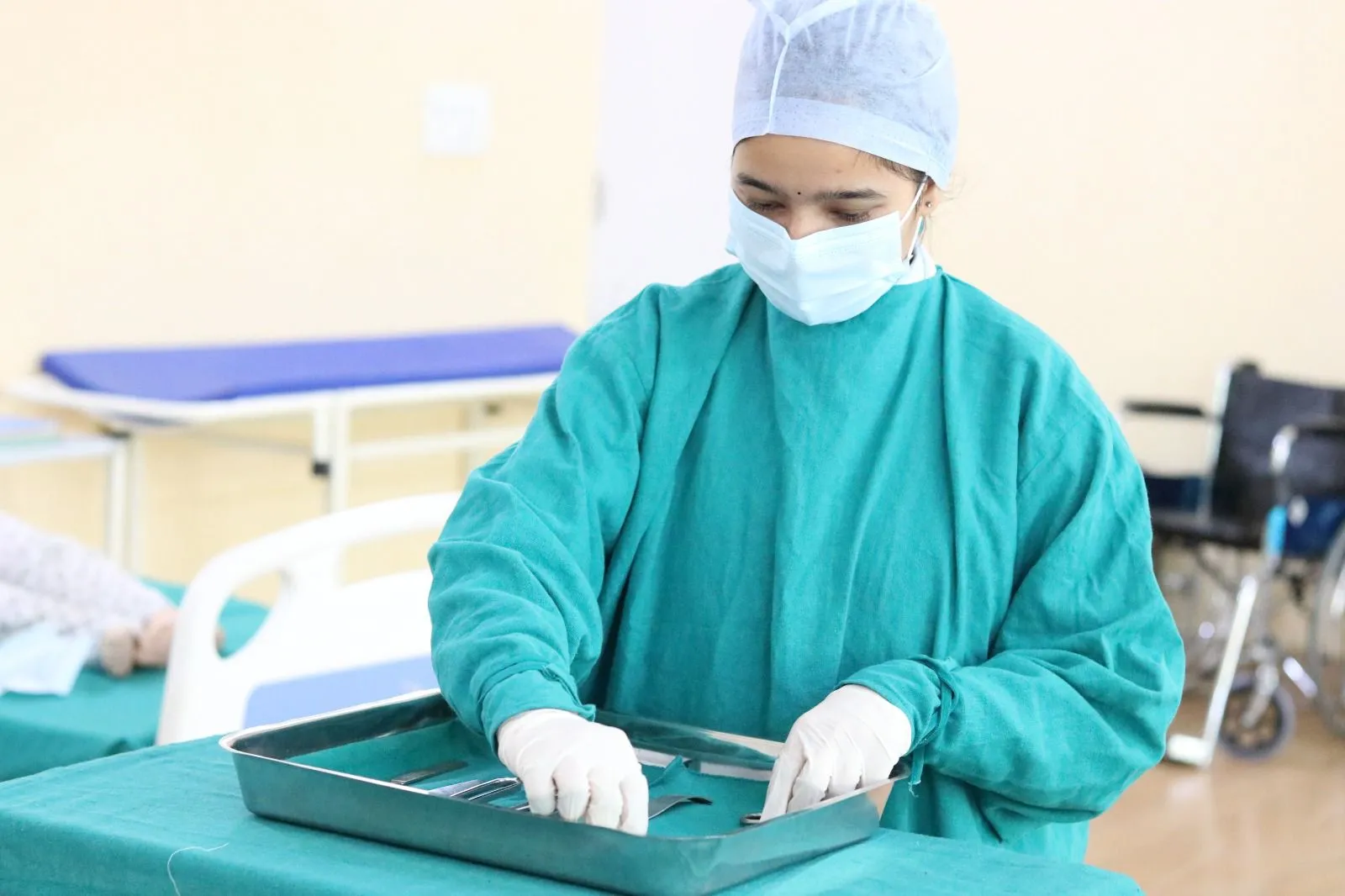 B.Sc OTT student laying out a surgical instrument tray during a practical session